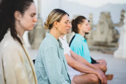 A group of people meditating.