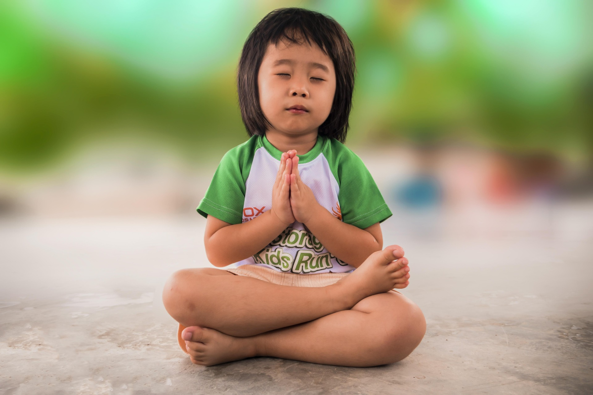 Small child doing a yoga pose. 